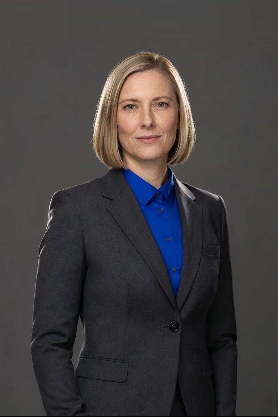 Anna Lindqvist, engineering lead — a woman in a charcoal trouser suit and cobalt shirt